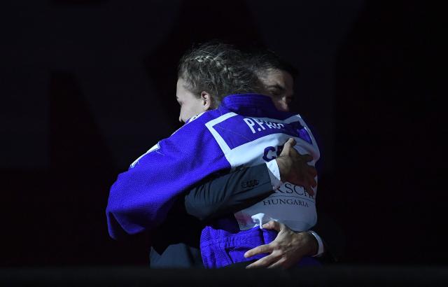 Croatia's Petrunjela Pavic is hugged after defeating Japan's Mao Izumi and winning the gold medal in the women's under 78kg category bout at the Hungary Grand Slam judo tournament, part of the IJF World Judo Tour, in Budapest on September 13, 2026. (Photo by Ferenc ISZA / AFP)