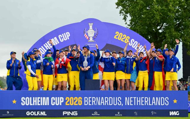 Team Europe’s Swedish captain Anna Nordqvist (C) holds the trophy after victory on the final day of the 2026 Solheim Cup biennial team golf competition on The Bernardus Golf Course at Cromvoirt, some 80kms south-east of Rotterdam on September 13, 2026. (Photo by NICOLAS TUCAT / AFP)