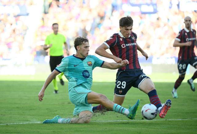 Barcelona's Spanish midfielder #07 Fermin Lopez fights for the ball with Levante's Spanish defender #29 Nacho Perez during the Spanish league football match between Levante UD and FC Barcelona at Ciutat de Valencia Stadium in Valencia on September 13, 2026. (Photo by JOSE JORDAN / AFP)