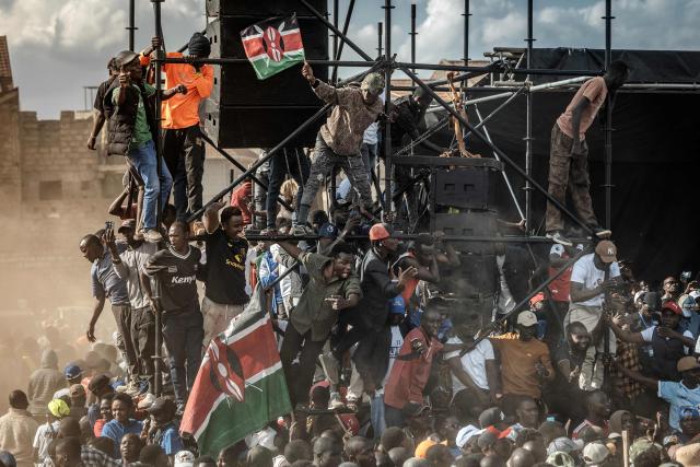 TOPSHOT - Supporters of the Kenyan opposition Linda Mwananchi (Protect Citizens) coalition wave flags and chant anti-government slogans as they attend an opposition rally in Nairobi on September 13, 2026.A heavy police presence was deployed in Nairobi for a rally by a rising opposition star on Sunday, following a wave of political violence in recent weeks. Edwin Sifuna has emerged as the loudest threat to President William Ruto ahead of the latter's bid for re-election in August 2027. Sifuna, 44, has built momentum by tapping into widespread anger over corruption and political violence, though others argue he is too young and inexperienced for the top office. (Photo by Luis TATO / AFP)