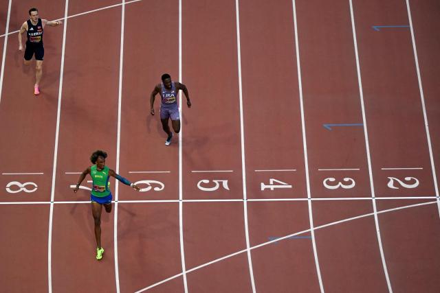 Brazil's Alison Dos Santos crosses the finish line ahead of US' Rai Benjamin (R) and Norway's Karsten Warholm (L) in men's 400m hurdles final during the World Athletics Ultimate Championship at the Gyula Zsivotzky National Athletics Centre, in Budapest on September 13, 2026. (Photo by Jewel SAMAD / AFP)