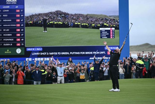 Ireland's Shane Lowry (R) celebrates his victory on the final hole of the Irish Open golf tournament at the Trump International Golf Links & Hotel, a resort and golf course owned by US President Donald Trump, in Doonbeg, western Ireland on September 13, 2026. (Photo by Brendan SMIALOWSKI / AFP)