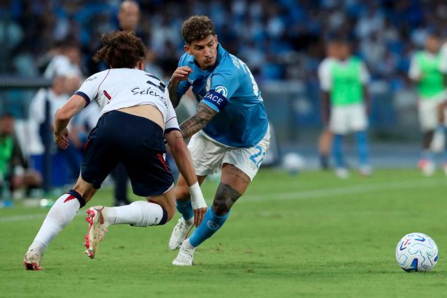 Napoli's Italian defender #22 Giovanni Di Lorenzo fights for the ball with Bologna's Belgian defender #3 Arthur Theate during the Italian Serie A football match SSC Napoli vs Bologna FC 1909 at the Diego Armando Maradona Stadium in Naples on September 13, 2026. (Photo by CARLO HERMANN / AFP)