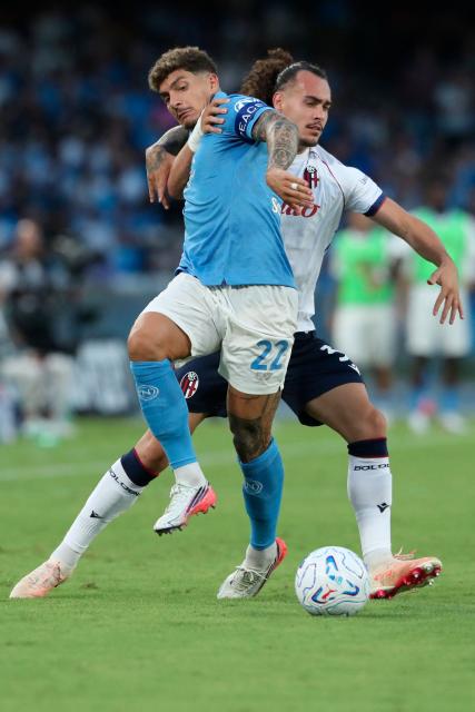 Napoli's Italian defender #22 Giovanni Di Lorenzo fights for the ball with Bologna's Belgian defender #3 Arthur Theate during the Italian Serie A football match SSC Napoli vs Bologna FC 1909 at the Diego Armando Maradona Stadium in Naples on September 13, 2026. (Photo by CARLO HERMANN / AFP)