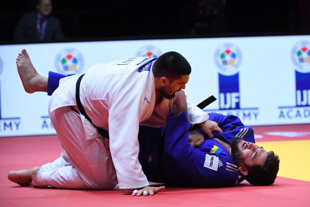 Azerbaijan’s Dzhamal Gamzatkhanov (white) and Ukraine’s Yakiv Khammo (blue) compete in the men’s over 100kg bronze medal contest at the Hungary Grand Slam 2026 judo tournament in Budapest, Hungary, on September 13, 2026. (Photo by Ferenc ISZA / AFP)