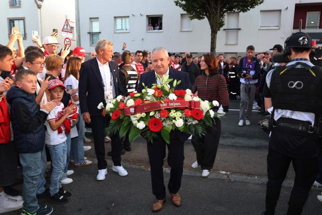 Stade Brestois's President Denis Le Saint walks to lay a wreath during a tribute ceremony for late Brest's coach Eric Roy before the French L1 football match between Stade Brestois 29 and Paris Saint-Germain (PSG) at the Stade Francis-Le Ble in Brest on September 13, 2026. Eric Roy died on June 17, 2026. (Photo by FRED TANNEAU / AFP)