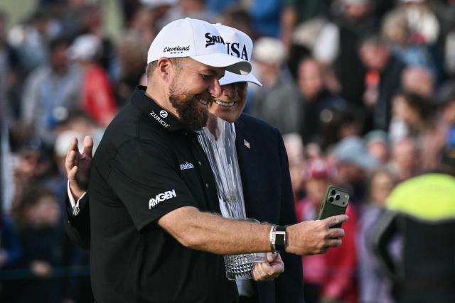 Ireland's Shane Lowry (L) takes a selfie with US President Donald Trump during the trophy presentation following his victory on the final day of the Irish Open golf tournament at the Trump International Golf Links & Hotel, a resort and golf course owned by the president, in Doonbeg, western Ireland on September 13, 2026. (Photo by Brendan SMIALOWSKI / AFP)