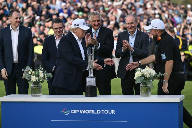 Ireland's Shane Lowry (R) shakes hands with US President Donald Trump (C) during the trophy presentation following his victory on the final day of the Irish Open golf tournament at the Trump International Golf Links & Hotel, a resort and golf course owned by the president, in Doonbeg, western Ireland on September 13, 2026. (Photo by Brendan SMIALOWSKI / AFP)