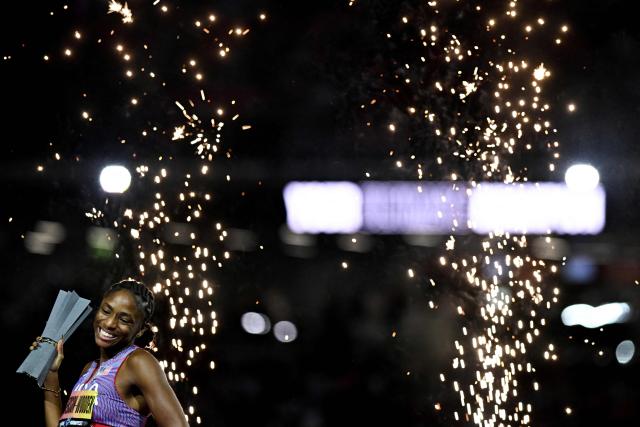 US' Melissa Jefferson-Wooden celebrates her victory with her trophy after the women's 200m final during the World Athletics Ultimate Championship at the Gyula Zsivotzky National Athletics Centre, in Budapest on September 13, 2026. (Photo by Jewel SAMAD / AFP)