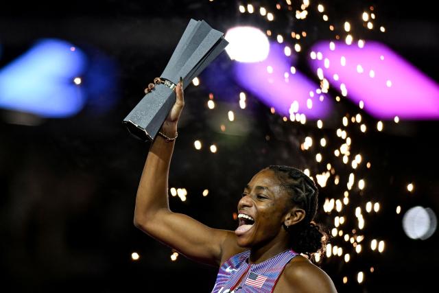 US' Melissa Jefferson-Wooden celebrates her victory with her trophy after the women's 200m final during the World Athletics Ultimate Championship at the Gyula Zsivotzky National Athletics Centre, in Budapest on September 13, 2026. (Photo by Jewel SAMAD / AFP)