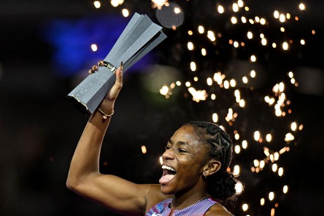 US' Melissa Jefferson-Wooden celebrates her victory with her trophy after the women's 200m final during the World Athletics Ultimate Championship at the Gyula Zsivotzky National Athletics Centre, in Budapest on September 13, 2026. (Photo by Jewel SAMAD / AFP)