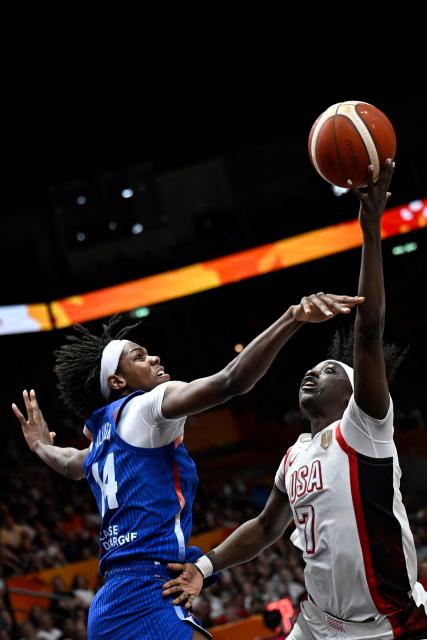 France's center #14 Dominique Malonga and USA's guard #07 Kahleah Copper vie for the ball during the 2026 FIBA Women’s Basketball World Cup final game between the United States and France in Berlin on September 13, 2026. (Photo by Tobias SCHWARZ / AFP)