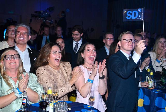 Sweden Democrats (SD) supporters cheer at the election night watch party at the Quality Hotel Strawberry Arena during Sweden's general election on September 13, 2026 in Stockholm. Opinion polls have long credited the four parties in the left-wing bloc with a comfortable lead over the conservative Prime Minister's four-party alliance, which includes the far-right Sweden Democrats. (Photo by Jonathan Nackstrand / AFP)