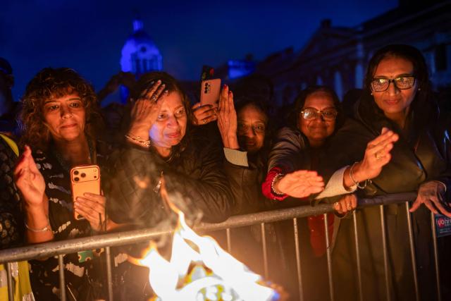 Participants attend a "Ceremony of Light: Ganga Aarti on the Thames" traditional Indian ritual, in the Greenwich area of south-east London on September 13, 2026. (Photo by Brook Mitchell / AFP)