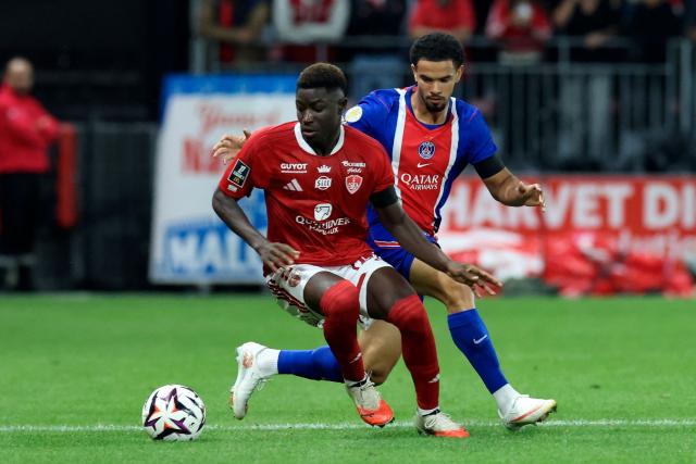 Brest's Senegalese forward #99 Pathe Mboup and Paris Saint-Germain's French midfielder #33 Warren Zaire-Emery fight for the ball during the French L1 football match between Stade Brestois 29 and Paris Saint-Germain (PSG) at the Stade Francis-Le Ble in Brest on September 13, 2026.  (Photo by FRED TANNEAU / AFP)