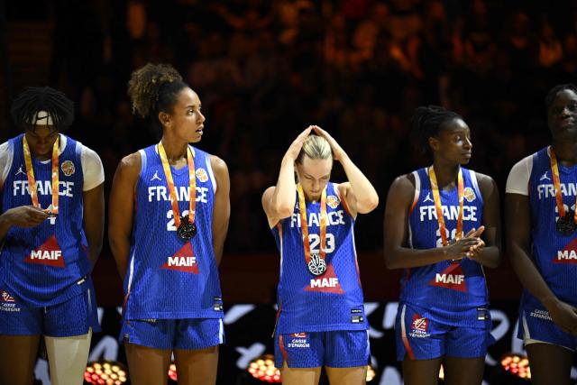 France's shooting guard #23 Marine Johannes (C) and team mates react with their silver medals after the 2026 FIBA Women’s Basketball World Cup final game between the United States and France in Berlin on September 13, 2026. (Photo by Tobias SCHWARZ / AFP)
