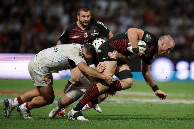 Toulouse's Irish lock Joshua Brennan (R) is tackled during the French Top 14 rugby union match between Stade Toulousain and Bordeaux-Begles at the Stade Ernest-Wallon in Toulouse, southwestern France on September 13, 2026.  (Photo by Valentine CHAPUIS / AFP)