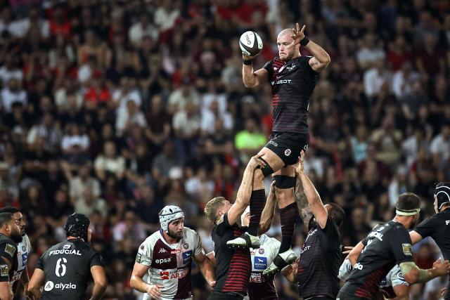 Toulouse's Irish lock Joshua Brennan (top) grabs the ball in a line out during the French Top 14 rugby union match between Stade Toulousain and Bordeaux-Begles at the Stade Ernest-Wallon in Toulouse, southwestern France on September 13, 2026.  (Photo by Valentine CHAPUIS / AFP)