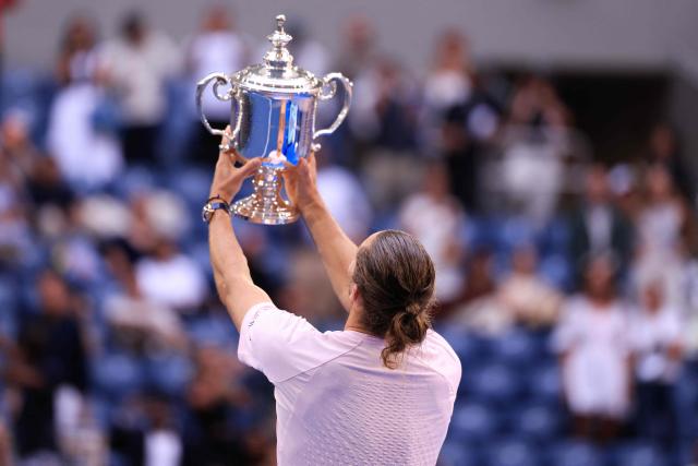 Germany's Alexander Zverev raises the trophy after defeating USA's Ben Shelton in the men's singles final tennis match on day fifteen of the US Open tennis tournament at the USTA Billie Jean King National Tennis Center in New York on September 13, 2026. (Photo by CHARLY TRIBALLEAU / AFP)