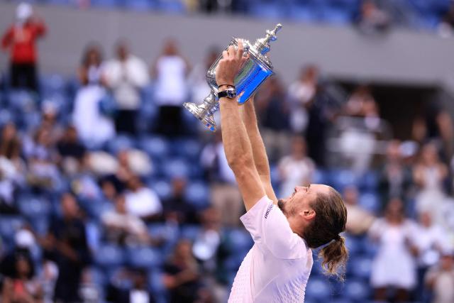 Germany's Alexander Zverev raises the trophy after defeating USA's Ben Shelton in the men's singles final tennis match on day fifteen of the US Open tennis tournament at the USTA Billie Jean King National Tennis Center in New York on September 13, 2026. (Photo by CHARLY TRIBALLEAU / AFP)