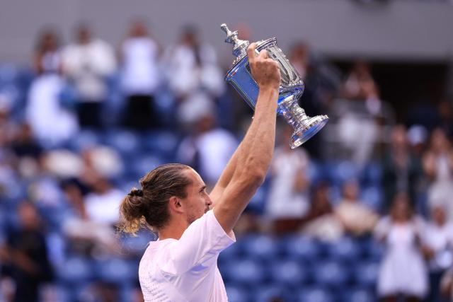 Germany's Alexander Zverev raises the trophy after defeating USA's Ben Shelton in the men's singles final tennis match on day fifteen of the US Open tennis tournament at the USTA Billie Jean King National Tennis Center in New York on September 13, 2026. (Photo by CHARLY TRIBALLEAU / AFP)