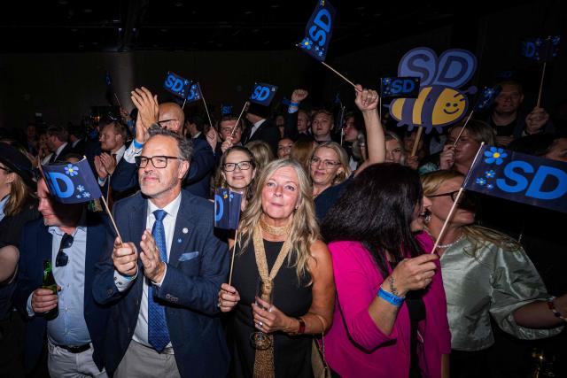 Supporters listen to far-right Sweden Democrats leader Jimmie Akesson deliver a speech at the party's election watch in Solna, near Stockholm, in the early hours of September 14, 2026. Sweden's leftwing opposition bloc held a razor-thin lead in Sunday's general election with half of votes counted, with the far right seen losing ground. (Photo by Jonathan NACKSTRAND / AFP)