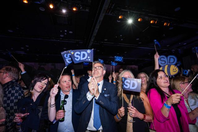 Supporters listen to far-right Sweden Democrats leader Jimmie Akesson deliver a speech at the party's election watch in Solna, near Stockholm, in the early hours of September 14, 2026. Sweden's leftwing opposition bloc held a razor-thin lead in Sunday's general election with half of votes counted, with the far right seen losing ground. (Photo by Jonathan NACKSTRAND / AFP)