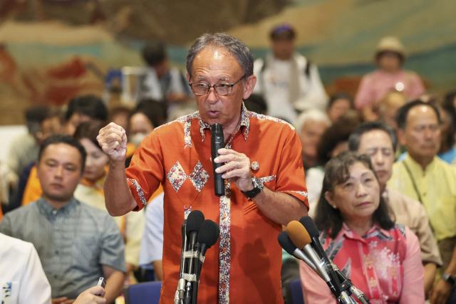 Denny Tamaki (2nd L) speaks to media after reports projected his defeat in the Okinawa gubernatorial election, in Naha, Okinawa prefecture on September 13, 2026. Tamaki, who was seeking his third term as governor of Okinawa, Japan's southernmost prefecture, lost to Genta Koja in the September 13 polls, bringing into power a leader who approves a contentious US military base relocation plan for the first time in 12 years. (Photo by JIJI PRESS / AFP) / Japan OUT