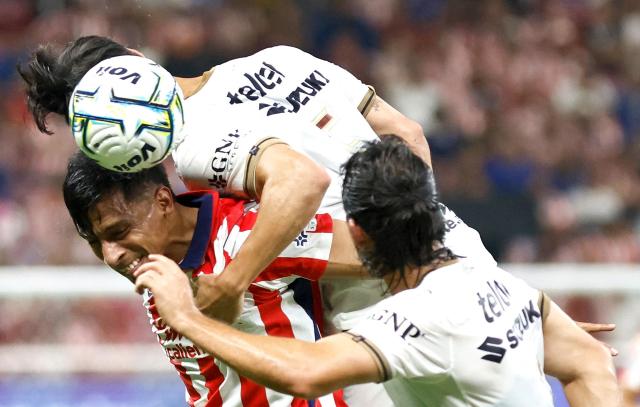 Guadalajara's forward #09 Angel Sepulveda (bottom) and Pumas' Spanish defender #05 Ruben Duarte fight for the ball during the Liga MX Apertura tournament football match between Guadalajara and Pumas at the Akron Stadium in Zapopan, Jalisco state, Mexico on September 13, 2026. (Photo by ULISES RUIZ / AFP)