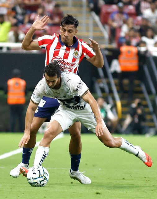Guadalajara's forward #09 Angel Sepulveda and Pumas' defender #02 Pablo Bennevendo fight for the ball during the Liga MX Apertura tournament football match between Guadalajara and Pumas at the Akron Stadium in Zapopan, Jalisco state, Mexico on September 13, 2026. (Photo by ULISES RUIZ / AFP)