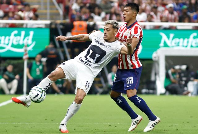 Pumas' forward #14 Luciano Herrera and Guadalajara's US midfielder #23 Daniel Aguirre fight for the ball during the Liga MX Apertura tournament football match between Guadalajara and Pumas at the Akron Stadium in Zapopan, Jalisco state, Mexico on September 13, 2026. (Photo by ULISES RUIZ / AFP)