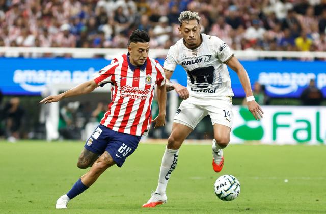 Guadalajara's forward #25 Roberto Alvarado and Pumas' forward #14 Luciano Herrera fight for the ball during the Liga MX Apertura tournament football match between Guadalajara and Pumas at the Akron Stadium in Zapopan, Jalisco state, Mexico on September 13, 2026. (Photo by ULISES RUIZ / AFP)