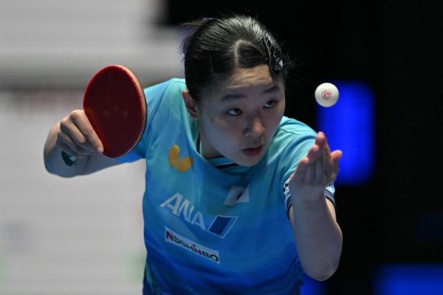 (FILES) Japan's Miwa Harimoto serves against China's Wang Manyu during their Women's Teams final match at the ITTF World Table Tennis Championships in Wembley Arena, west London on May 10, 2026. Tomokazu Harimoto and his younger sister Miwa have followed in their parents' footsteps by becoming professional table tennis players -- but took their own path by representing Japan instead of rivals China. (Photo by Glyn KIRK / AFP)