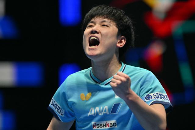 (FILES) Japan's Tomokazu Harimoto reacts against China's Liang Jingkun during their Men's Teams final match at the ITTF World Table Tennis Championships in Wembley Arena, west London on May 10, 2026. Tomokazu Harimoto and his younger sister Miwa have followed in their parents' footsteps by becoming professional table tennis players -- but took their own path by representing Japan instead of rivals China. (Photo by Glyn KIRK / AFP)