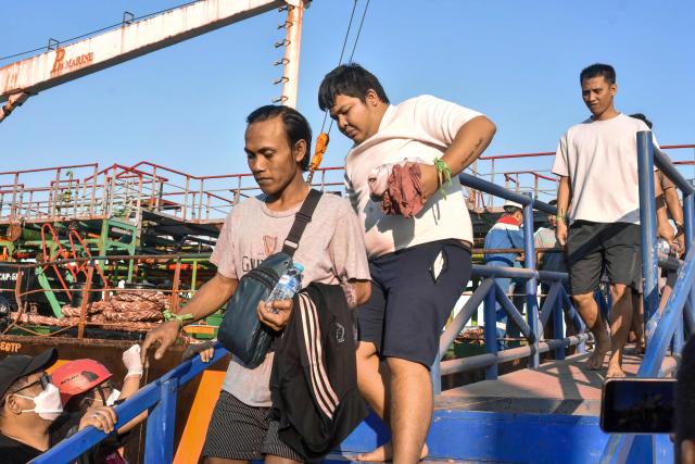 Survivors of the Virgo Transport 8 passenger ferry, which capsized September 13 carrying 213 passengers and 30 crew while en route from Banjarmasin to Surabaya, disembark following their rescue at the port in Banjarmasin, South Kalimantan, on September 14, 2026. Indonesian rescuers searched on September 14 for more than 100 people missing after a ferry capsized in rough seas, with aircraft, naval vessels and divers deployed to find survivors, the country's top rescue official said. (Photo by MUDA SAGALA / AFP)