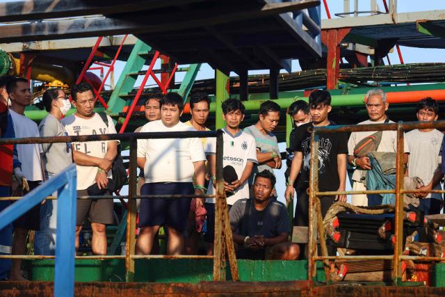 Survivors of the Virgo Transport 8 passenger ferry, which capsized September 13 carrying 213 passengers and 30 crew while en route from Banjarmasin to Surabaya, wait to disembark following their rescue at the port in Banjarmasin, South Kalimantan, on September 14, 2026. Indonesian rescuers searched on September 14 for more than 100 people missing after a ferry capsized in rough seas, with aircraft, naval vessels and divers deployed to find survivors, the country's top rescue official said. (Photo by MUDA SAGALA / AFP)