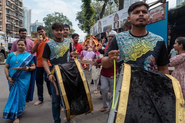 Devotees carry an idol of Hindu deity Ganesha, during a procession of the ‘Ganesh Chaturthi’ festival in Mumbai on September 14, 2026. (Photo by Punit PARANJPE / AFP)