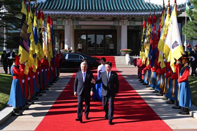 Uzbekistan's President Shavkat Mirziyoyev (L) and South Korea's President Lee Jae Myung (R) attend a welcoming ceremony at the presidential Blue House in Seoul on September 14, 2026, on the sidelines of the 1st Korea-Central Asia Summit. (Photo by JUNG YEON-JE / POOL / AFP)