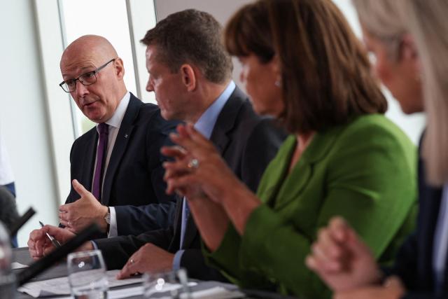 Scottish Nationalist Party (SNP) leader John Swinney (L) speaks as (2nd L to R) Rhun ap Iorwerth of Plaid Cymru in Wales, Mary Lou McDonald, president of Irish Republicans Sinn Fein and Michelle O'Neill, vice president of Irish Republicans Sinn Fein look on, as they attend a meeting in Cardiff, Wales on September 14, 2026, to press for self-determination votes in their territories. The leaders of the main Scottish, Welsh and Northern Irish separatist parties were to hold rare talks on September 14 aiming to advance their campaigns to break away from Britain, they announced in a statement. (Photo by Adrian Dennis / AFP)