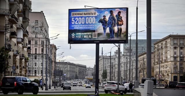 A billboard promoting contract army service and reading "5 200 000 rubles for the first year of the contract" (about USD 61 700) is seen in western Moscow on September 14, 2026. (Photo by Alexander NEMENOV / AFP)