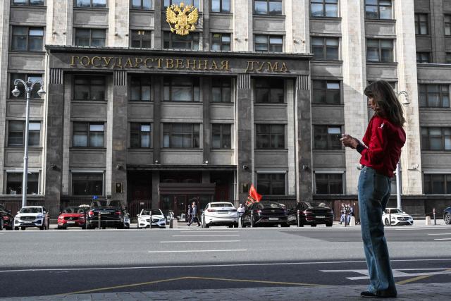 A woman stands in the street in front of the Russian State Duma (lower house of Russia's Parliament) in central Moscow on September 14, 2026. The 2026 parliamentary election will be held over a three-day period from September 18 to 20. (Photo by Igor IVANKO / AFP)