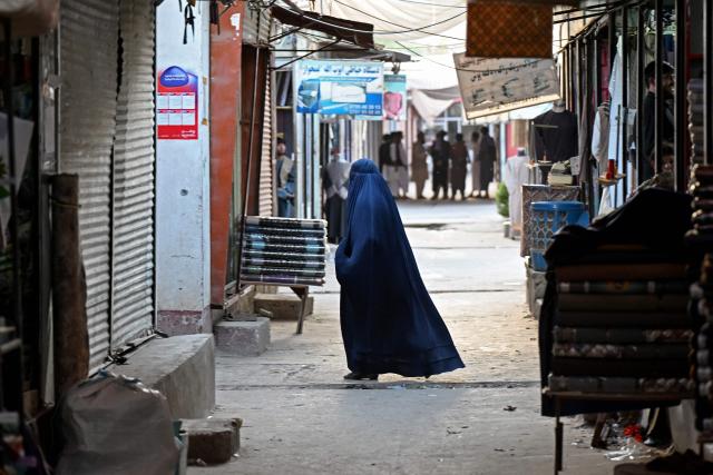 An Afghan burqa-clad woman visits a marketplace in the Fayzabad district of Afghanistan's Badakhshan province on September 14, 2026. (Photo by OMER ABRAR / AFP)