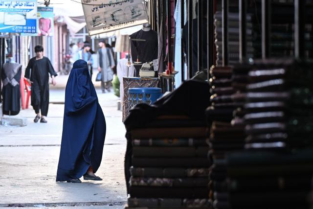 An Afghan burqa-clad woman visits a marketplace in the Fayzabad district of Afghanistan's Badakhshan province on September 14, 2026. (Photo by OMER ABRAR / AFP)