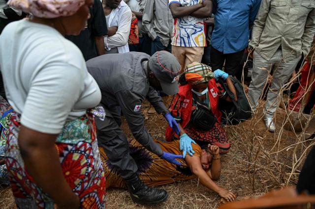 A mother cries for her children who died in the fire and, inconsolable, watches as their bodies arrive at Ruzizi cemetery for their collective burial, following the official funeral ceremony for the children who died in the blaze in Bukavu, on September 14, 2026. A fire and stampede at a school in the eastern Democratic Republic of Congo killed at least 26 children, the UN children's agency said on Friday, with some pupils leaping from windows on high floors to escape the carnage. (Photo by Jospin Mwisha / AFP)