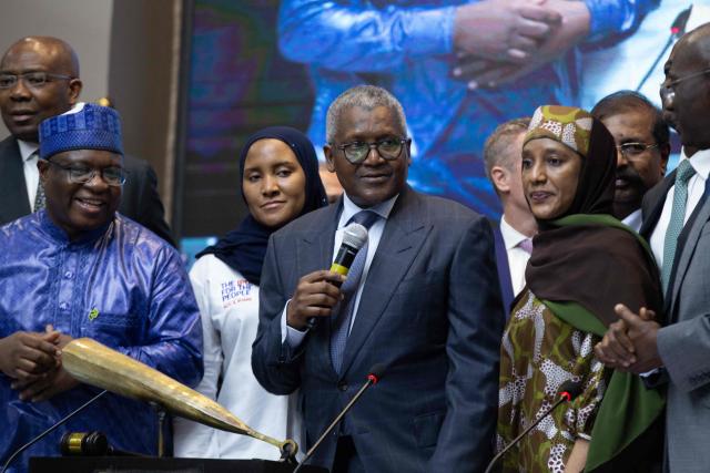 Aliko Dangote (C) the President and Chief Executive Officer of the Dangote Group, addresses the audience during the Dangote Refinery's inital public offering (IPO) at the Nigerian Exchange Group in Lagos, NIgeria on September 14, 2026. Nigerian billionaire Aliko Dangote on Monday launched what is slated as Africa's biggest initial public offering, which aims to raise $1.6 billion from his mega oil refinery.
Describing it as an "historic day", Dangote said in a statement that the IPO was "not simply about listing a company. It is about listing a new possibility for Nigeria, and for Africa". (Photo by Temiloluwa Johnson / AFP)