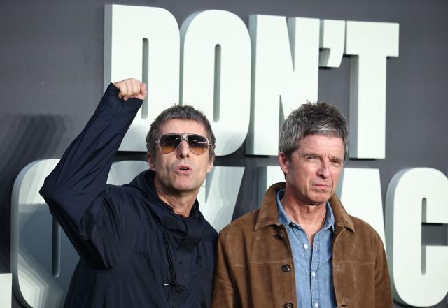 (FILES) British Musicians and Oasis singers Liam Gallagher (L) Noel Gallagher react as they pose upon arrival on the red carpet for the UK premiere of the film 'Oasis: Don't Look Back In Anger', in Leicester Square in central London on September 7, 2026. British rockers Oasis on September 14, announced a new world tour in 2027 with shows planned in Britain, Europe, and the US after the sell-out success of their surprise comeback tour last year. (Photo by Henry NICHOLLS / AFP)