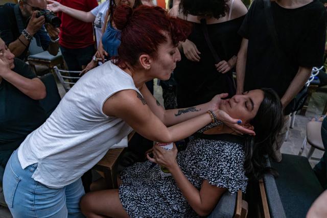 People help a protester suffering from the effects of tear gas during a demonstration against the arrests of LGBTQ activists in Izmir, on September 14, 2026. Turkish police fired tear gas at demonstrators in the western city of Izmir on September 14, 2026 as they protested against the growing targeting of LGBTQ activists, an AFP photographer reported. The rally came a day after police carried out sweeping nationwide raids, arresting dozens of people in a campaign the government said was aimed at promoting traditional family values. (Photo by Murat Kocabas / AFP)