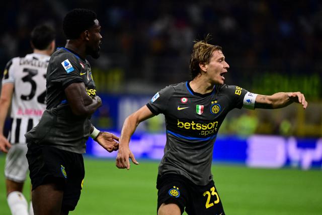 Inter Milan's Italian midfielder #23 Nicolo Barella celebrates after scoring his team second goal during the Italian Serie A football match between Inter Milan and Udinese at the San Siro Stadium in Milan, Italy on September 14, 2026. (Photo by Piero CRUCIATTI / AFP)