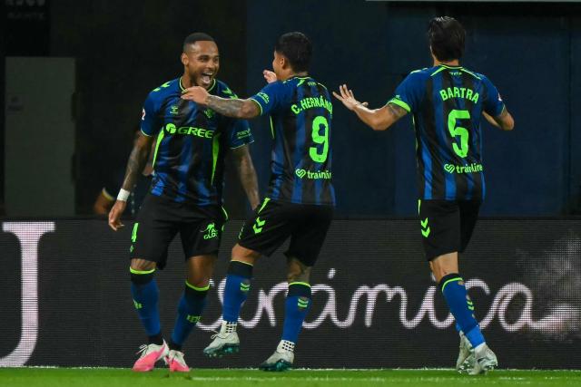 Real Betis' Brazilian defender #04 Natan Bernardo de Souza (L) celebrates scoring his team's second goal during the Spanish league football match between Villarreal CF and Real Betis at La Ceramica Stadium in Vila-real on September 14, 2026. (Photo by JOSE JORDAN / AFP)