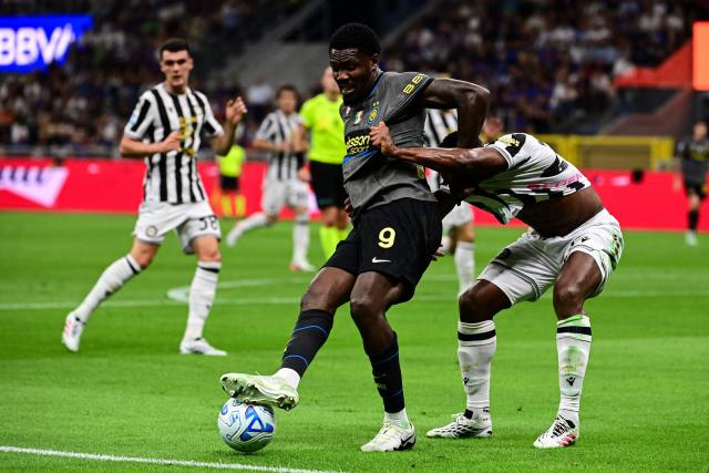 Inter Milan's French forward #09 Marcus Thuram fights for the ball with Udinese's Belgian defender #27 Christian Kabasele during the Italian Serie A football match between Inter Milan and Udinese at the San Siro Stadium in Milan, Italy on September 14, 2026. (Photo by Piero CRUCIATTI / AFP)